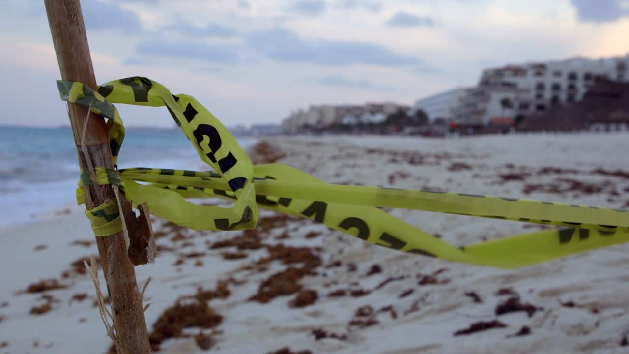 Police tape on the beach in Cancun.