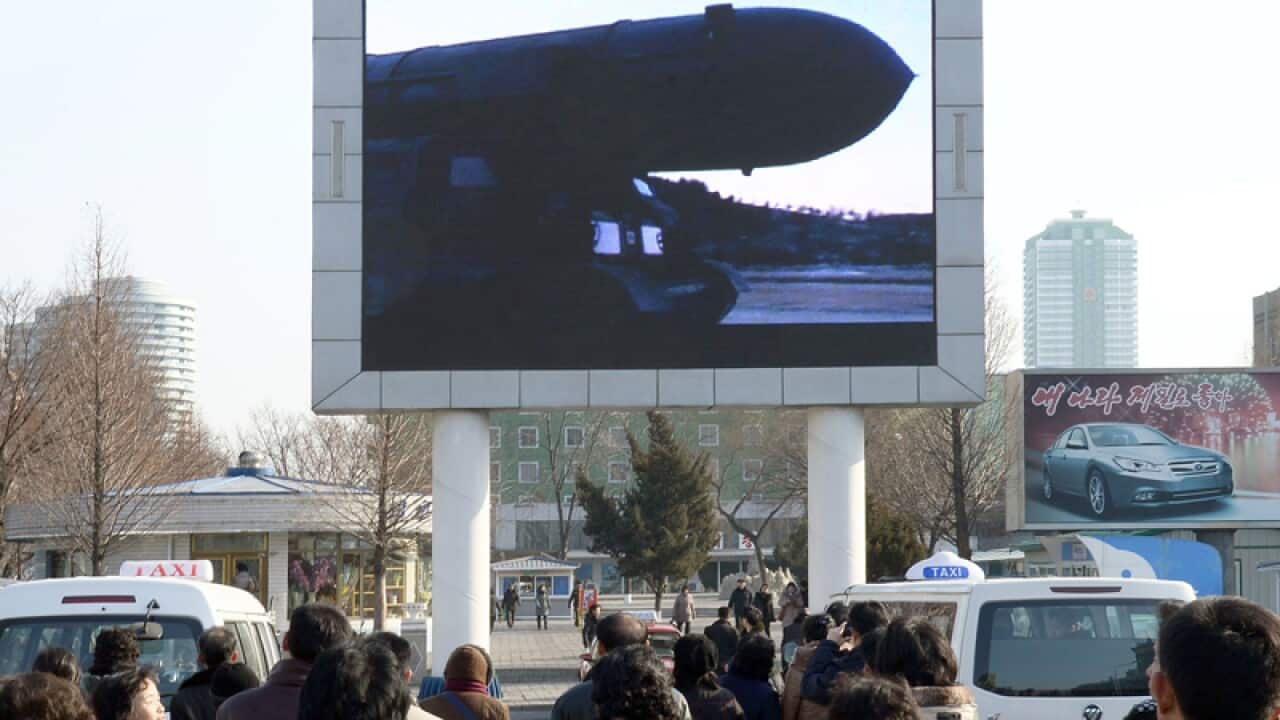 People in Pyongyang watch the news of a test-fire