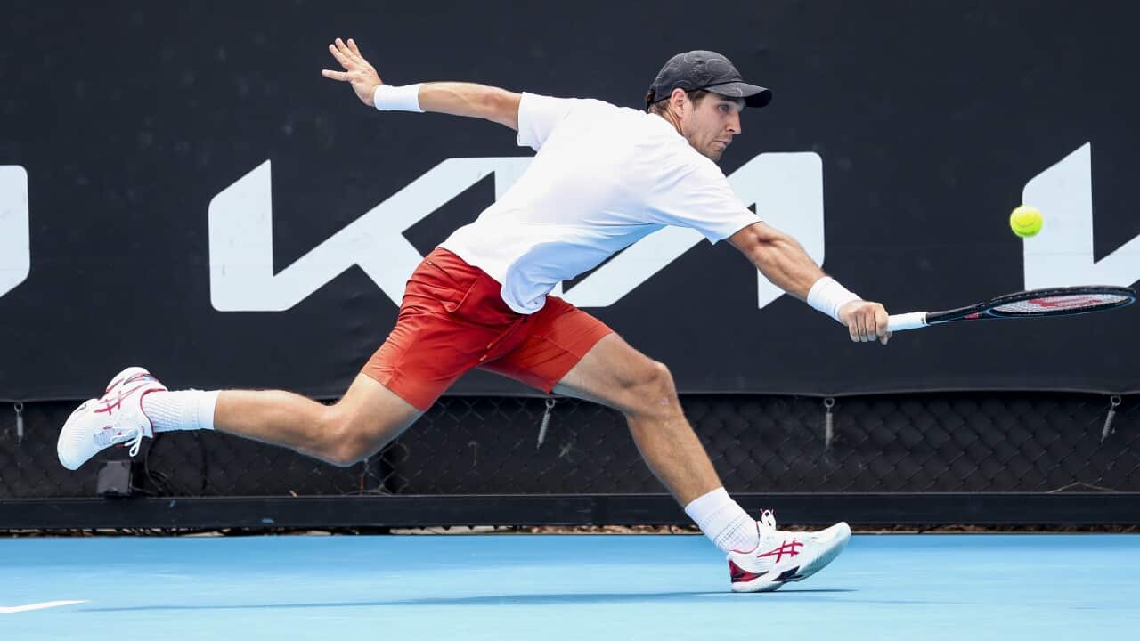 epa09690416 Dusan Lajovic of Serbia in action against Marton Fucsovics of Hungary during their first round match at the Australian Open Grand Slam tennis tournament in Melbourne, Australia, 17 January 2022. EPA/JASON O'BRIEN