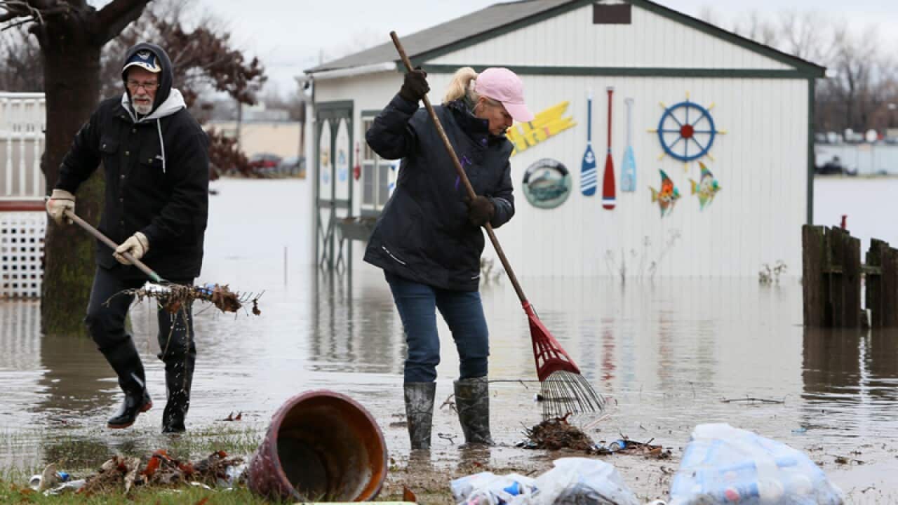 Charles and Donna Campbell clear their the yard in Pontoon Beach