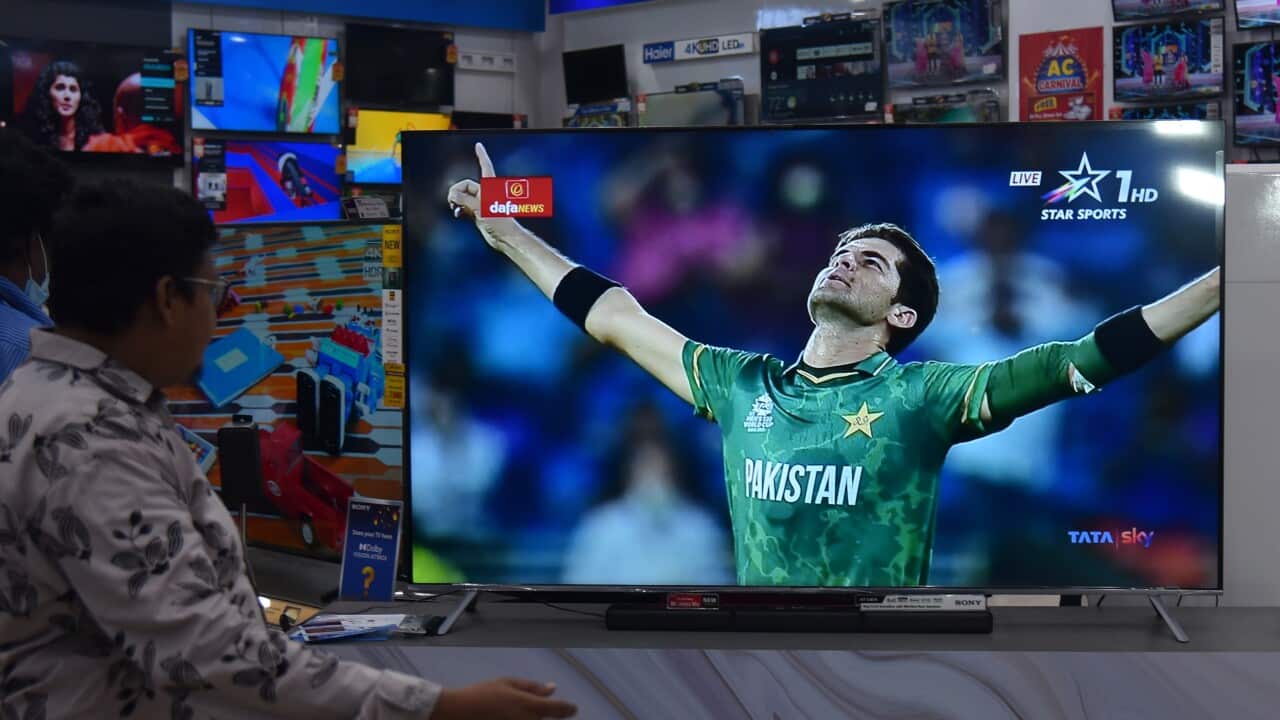 An Indian cricket fan watches the first match between India and Pakistan International Cricket T20 World Cup Super 12 stage in Dubai, live on a television screen at an electronic store, in Chennai, India, 24 October 2021. EPA/IDREES MOHAMMED