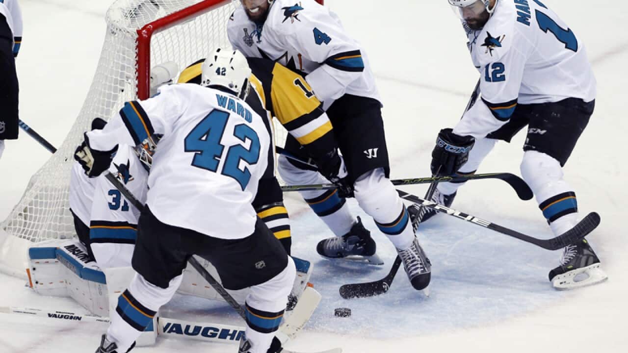 San Jose Sharks players scramble for a loose puck