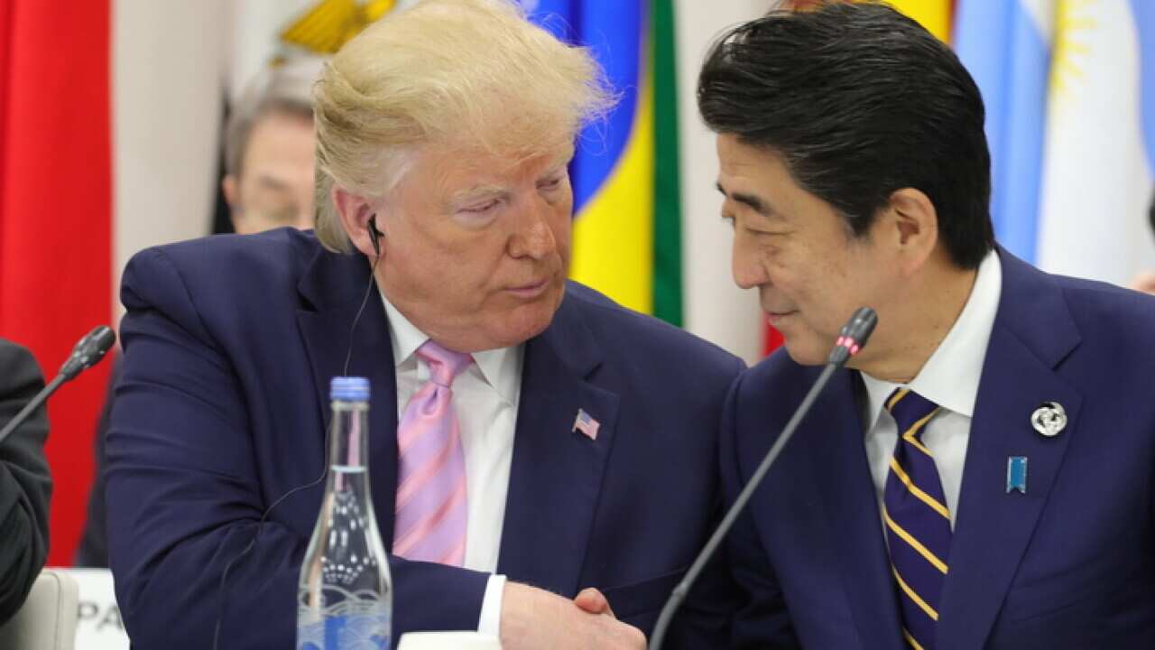 US President Donald J.Trump (L) shakes hands with Japanese Prime Minister Shinzo Abe (R)