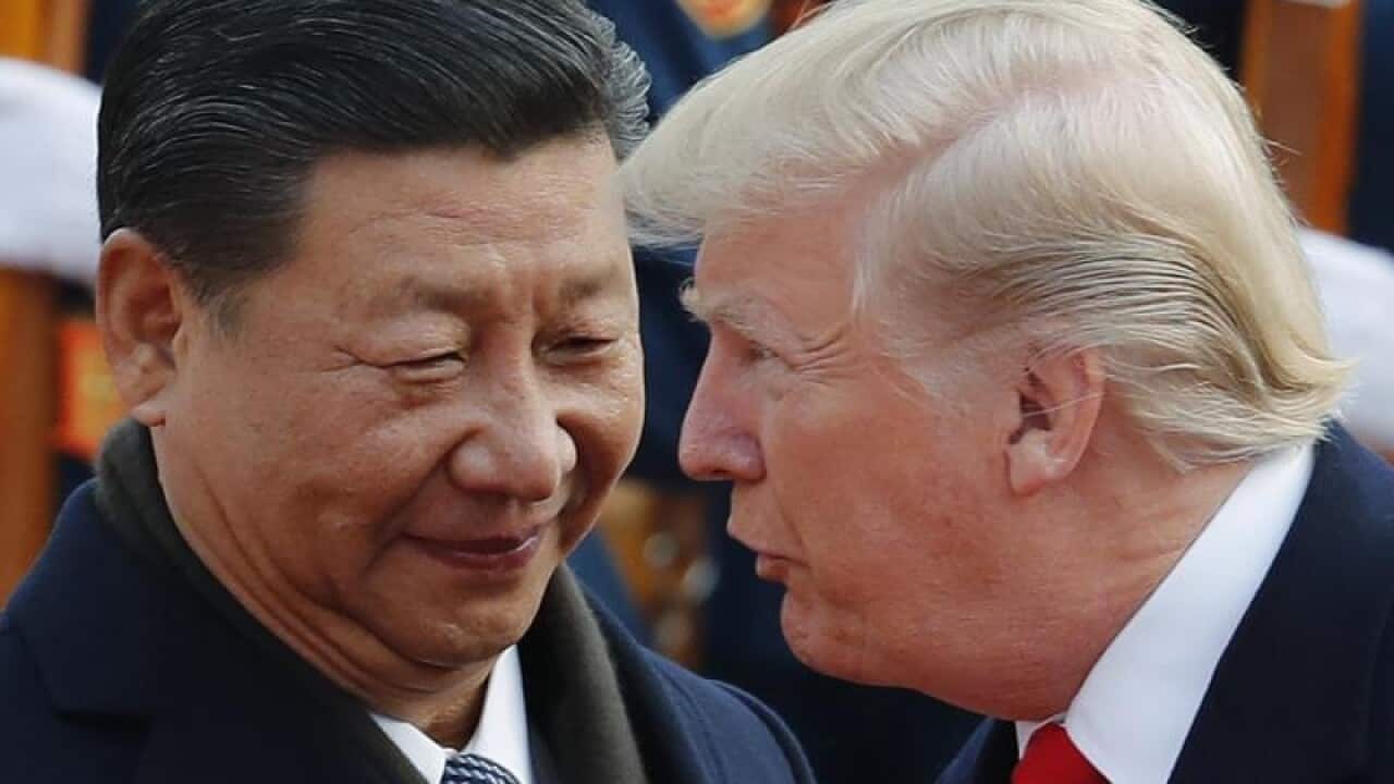 US President Donald Trump talks to Chinese President Xi Jinping
