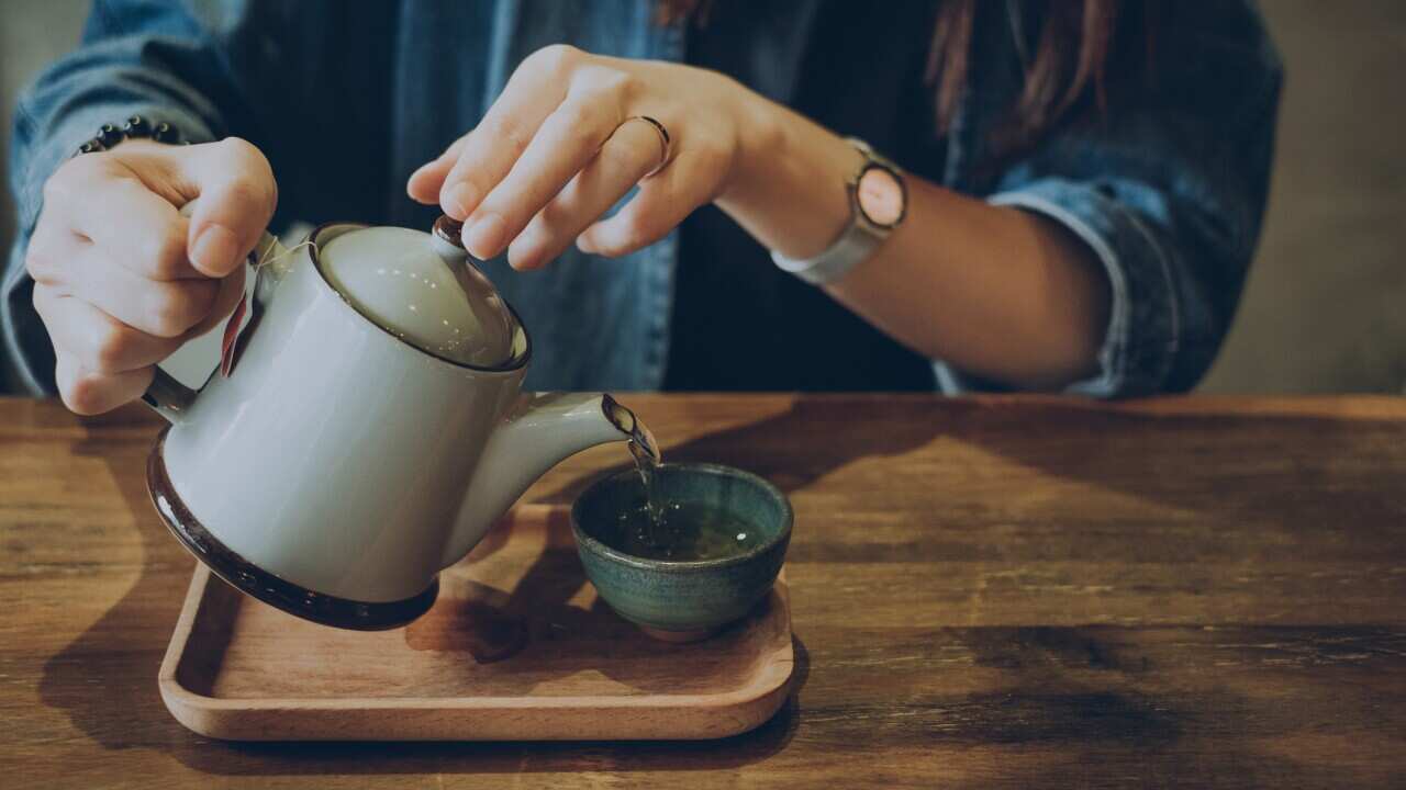 Woman enjoying a quiet time with a fresh cup of tea