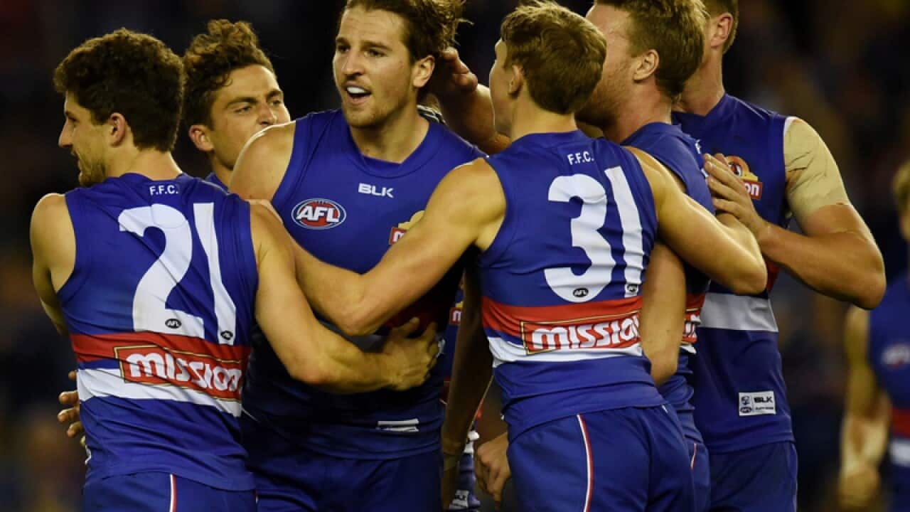 Western Bulldogs players celebrate after the siren