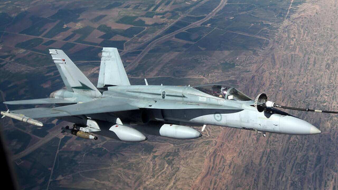 A supplied image obtained Tuesday April 28, 2015, A RAAF F/A-18A Hornet aircraft air to air refuels from a RAAF KC-30A tanker aircraft during a mission in the Middle East Region on Operation OKRA.