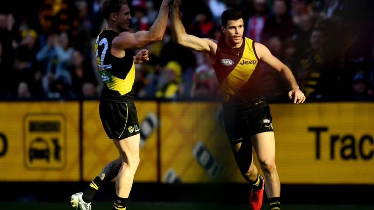 Josh Caddy and Trent Cotchin of the Tigers.