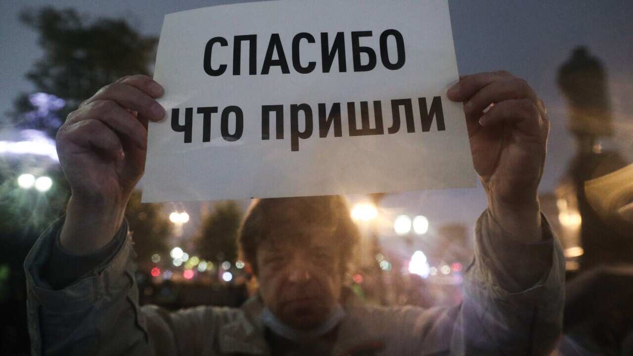 A demonstrator holds a sign with a message reading "Thank You For Coming" during an unsanctioned protest in central Moscow against the results of the 2021 Russian parliamentary election.