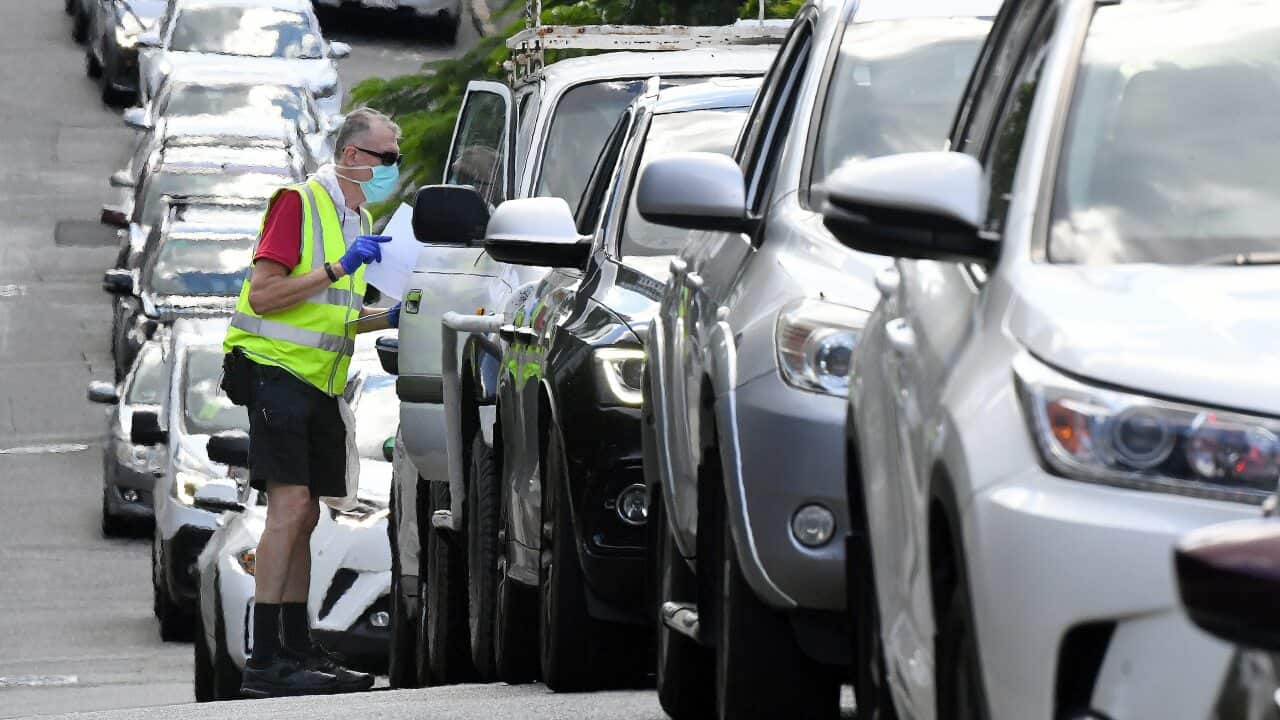 Brisbane residents queue to be processed through a drive-in COVID testing site at Bowen Hills in Brisbane, Monday, March 29, 2021