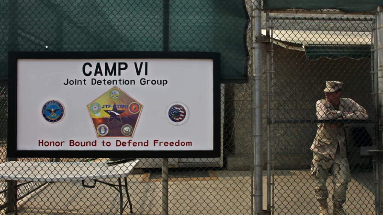 A soldier stands guard at the entrance to Guantanamo Bay's Camp 6