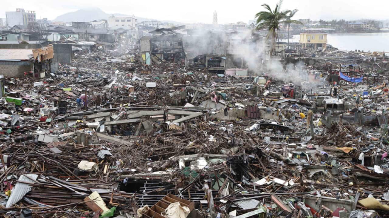 Typhoon survivors sift through the debris after Typhoon Haiyan.