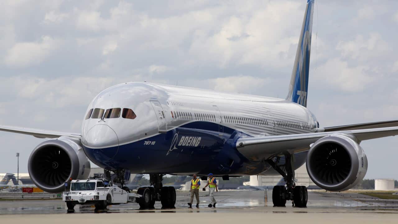 Boeing employees walk the new Boeing 787-10 Dreamliner down towards the delivery ramp area at the company's facility in South Carolina