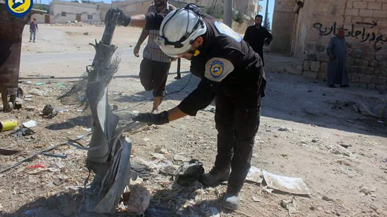 Syrian Civil Defense group known as the White Helmets inspect the cluster bombs in the Khan Sheikhoun neighborhood of Idlib