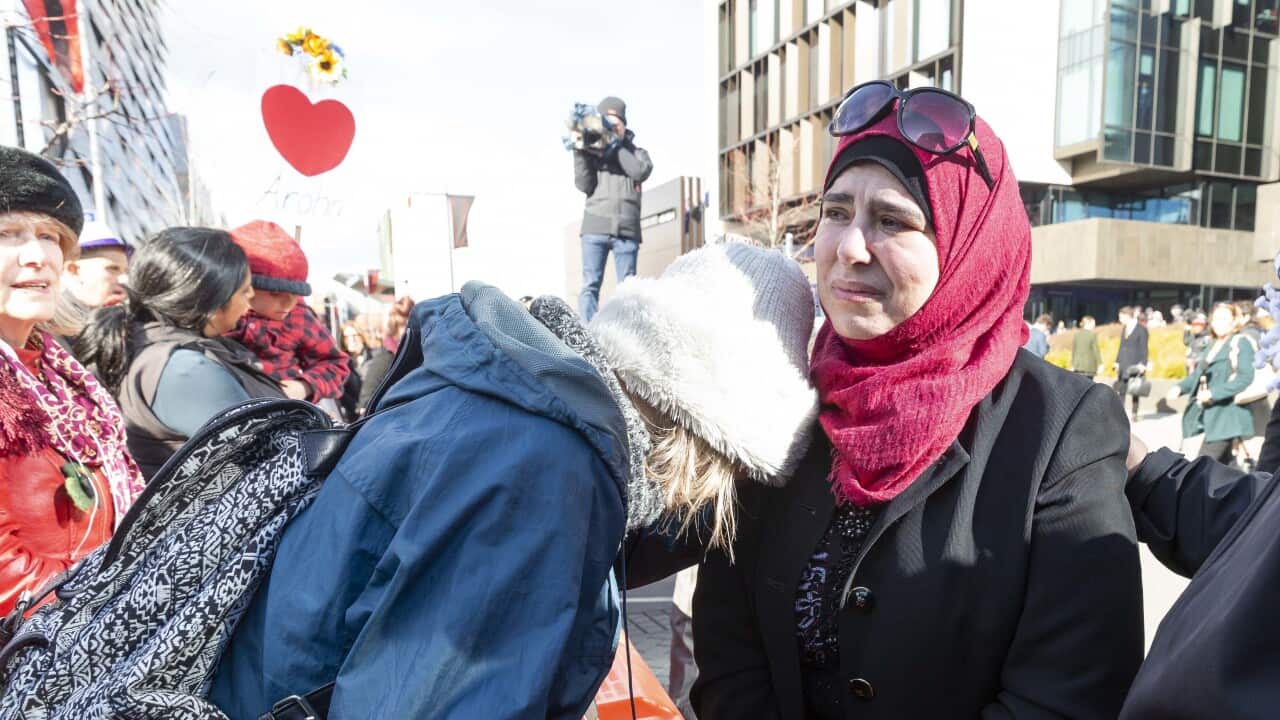 Emotional people embrace on the street.