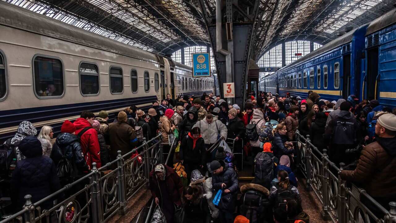 A crowd of people at a train station