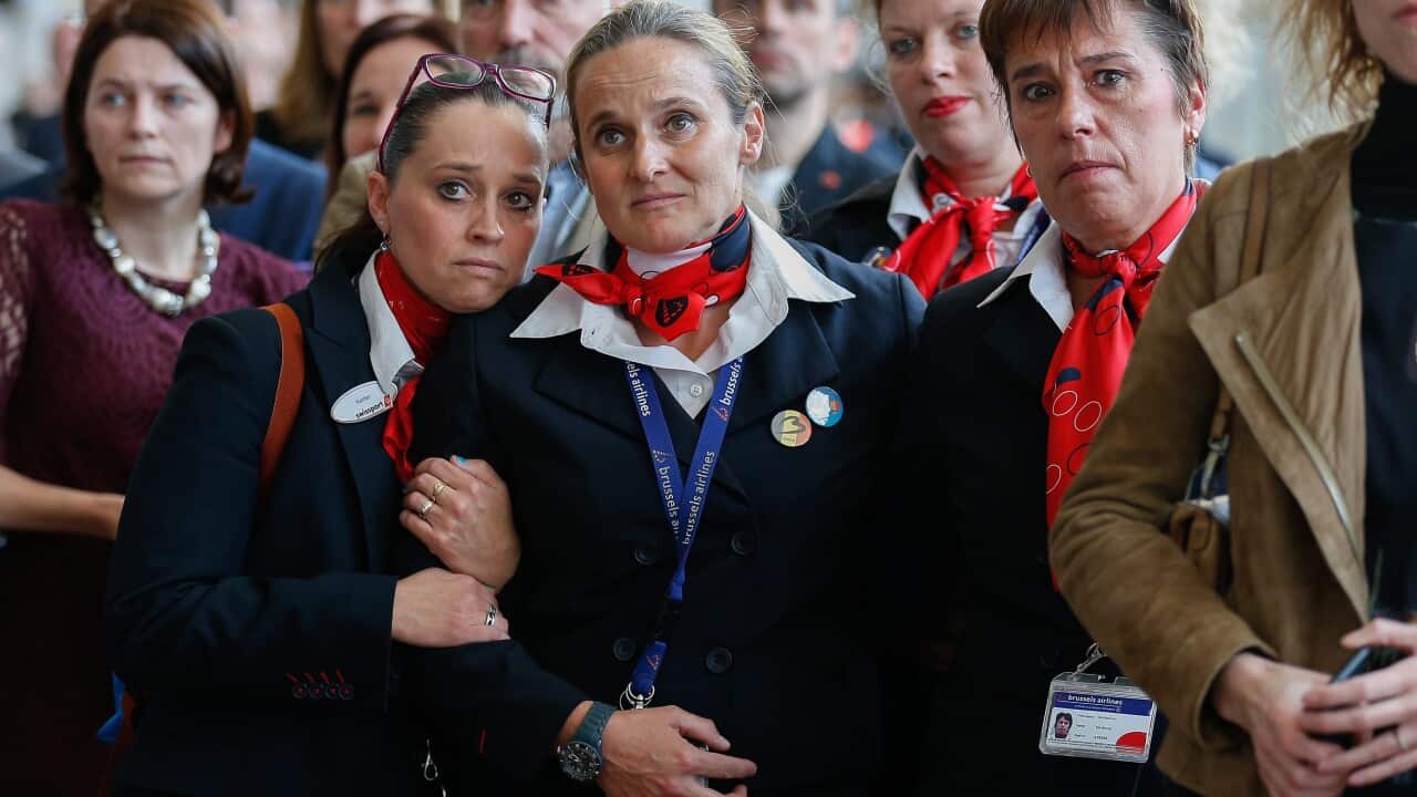 Airport staff react during a speech of Belgian Prime Minister Charles Michel (unseen) at Brussels airport in Zaventem, Brussels, Belgium, 01 May 2016.