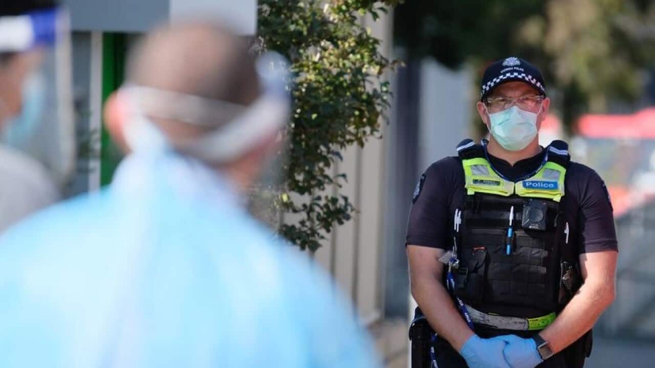 A policeman stands outside the Holiday Inn.