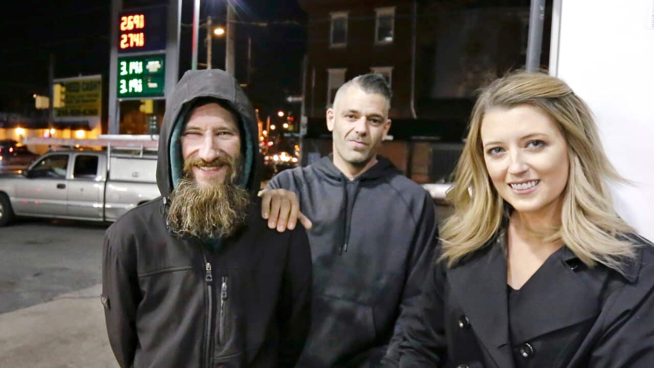 Johnny Bobbitt Jr., left, Kate McClure, right, and McClure's boyfriend Mark D'Amico pose at a Citgo station in Philadelphia.