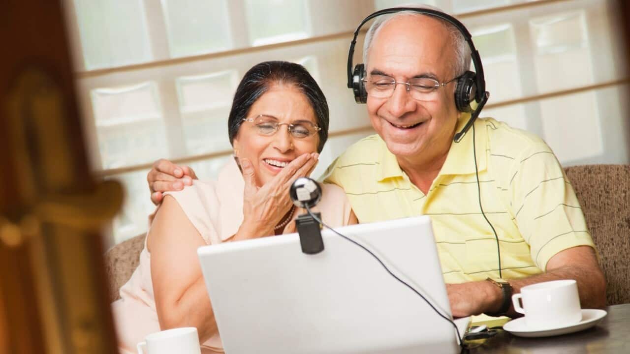 Couple looking at computer screen.