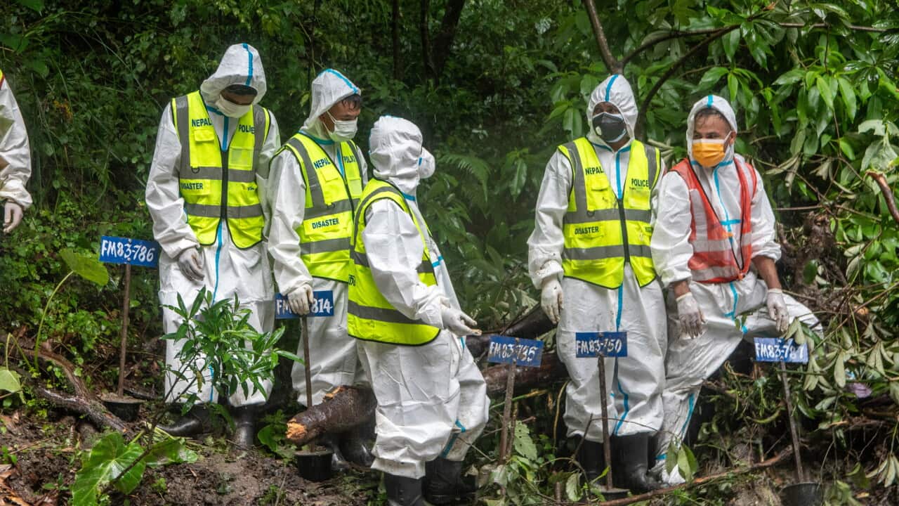 Rescue workers and officials manage a mass burial trench for unidentified remains recovered after severe flash floods in Gokarna, Kathmandu on 1 September 2026.