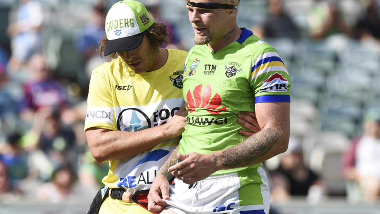 Blake Austin of the Raiders leaves the field with a injury