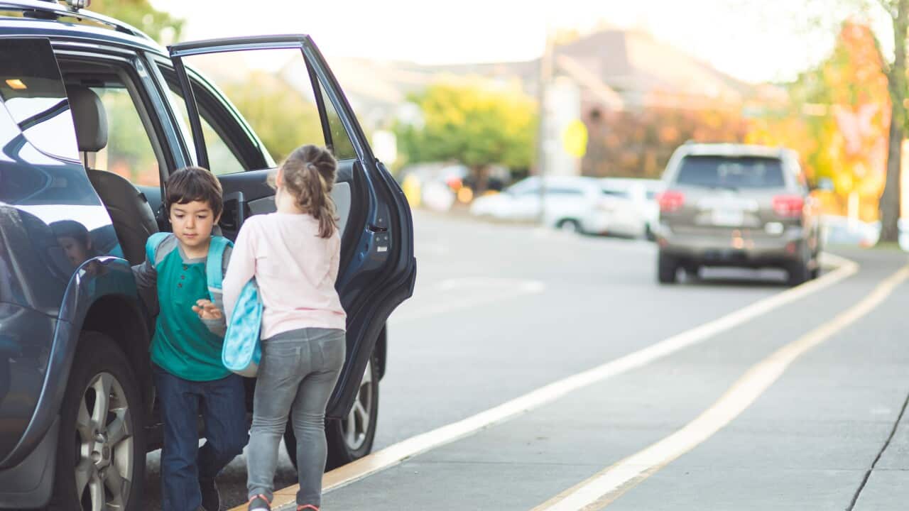 Two young students getting picked up from school