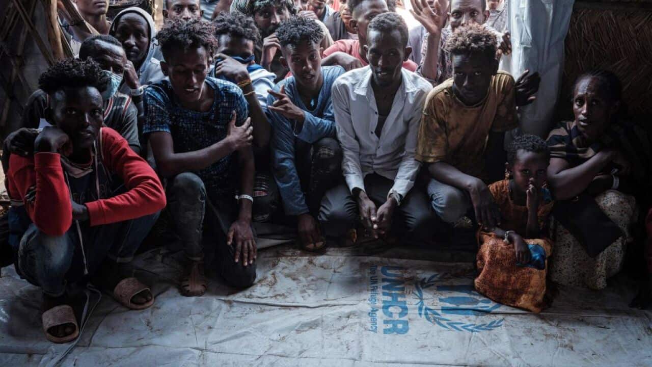 Ethiopian refugees who fled the Tigray conflict, wait to register for food aid at Um Raquba reception camp in Sudan's eastern Gedaref state on 3 December, 2020.