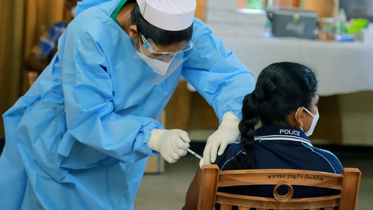 A police officer gets a COVID-19 vaccination in Colombo, Sri Lanka .