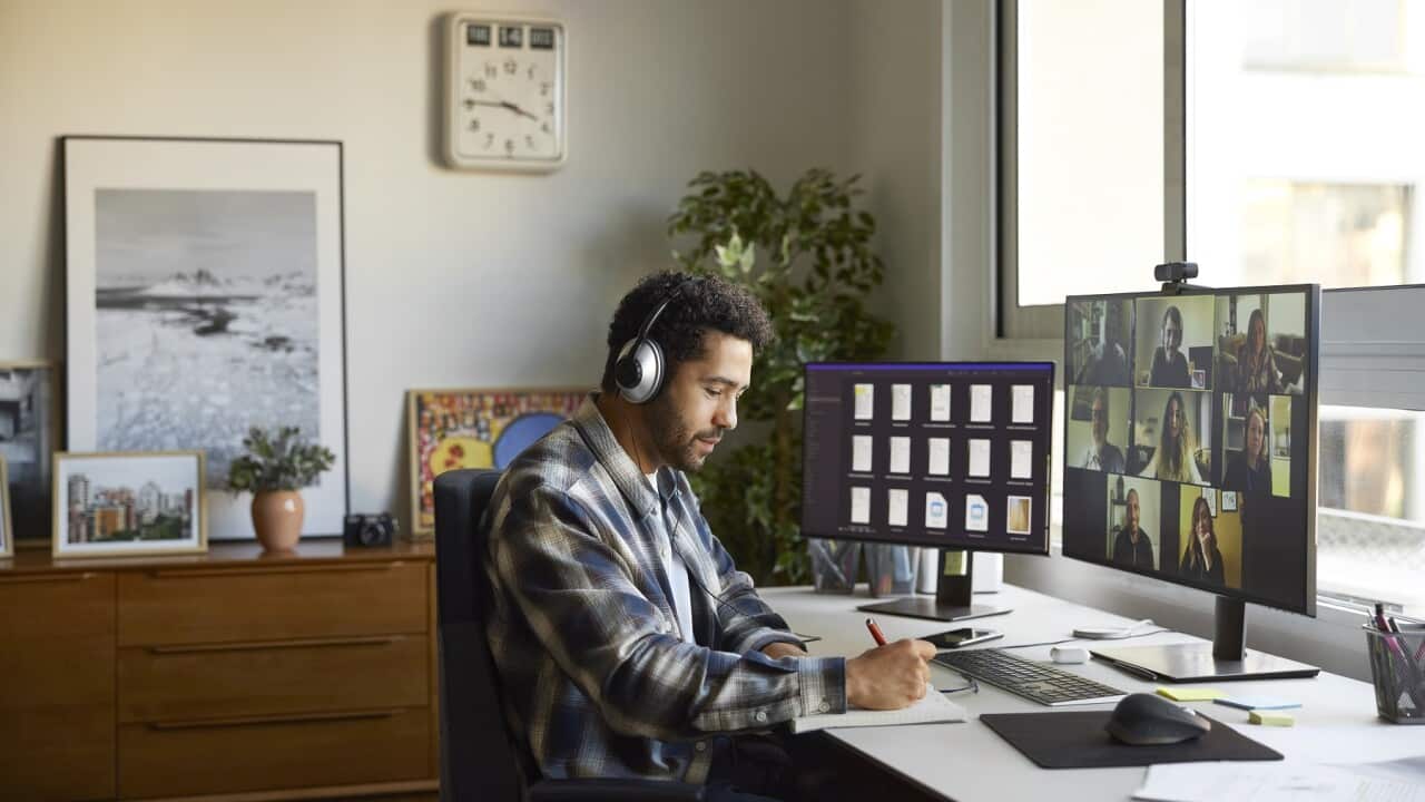 Businesswoman writing in diary at home office
