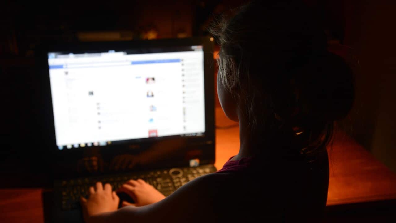 A young girl uses a personal computer in Brisbane, Wednesday, Oct. 16, 2013. (AAP Image/Dan Peled) NO ARCHIVING
