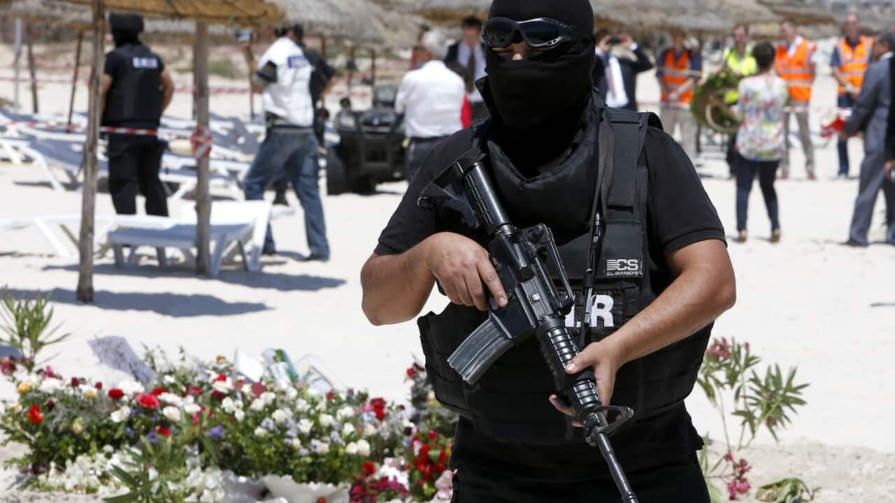 File photo: A hooded Tunisian police officer stands guard ahead of the visit of top security officials of Britain, France, Germany and Belgium at the scene of shooting at the Imperial Marhaba hotel in Sousse.