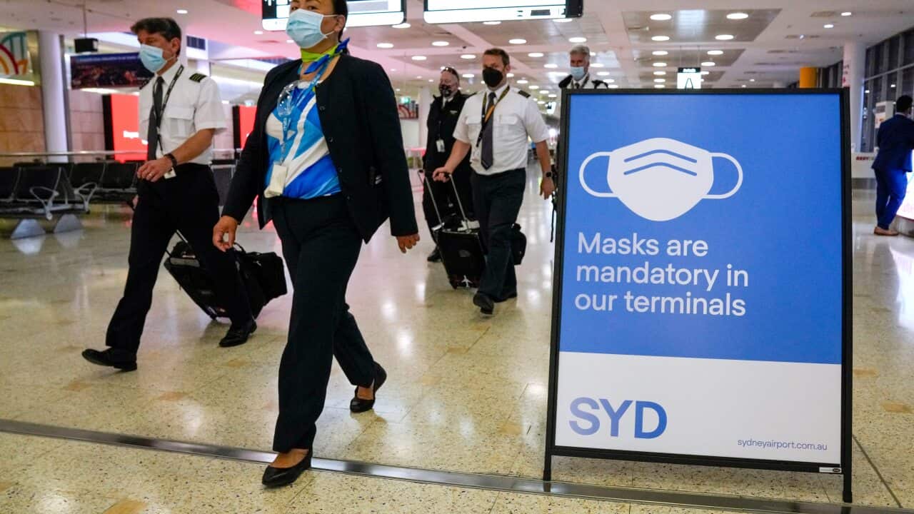 A flight crew walk through the terminal at Sydney Airport