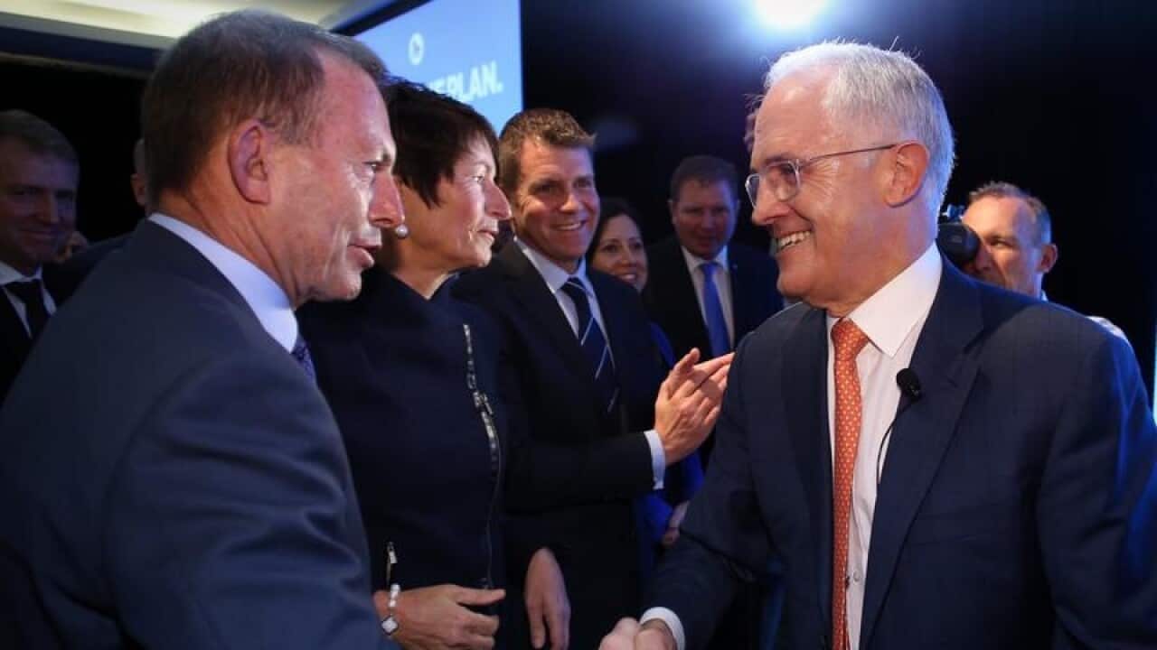 Tony Abbott shakes hands with Malcolm Turnbull.