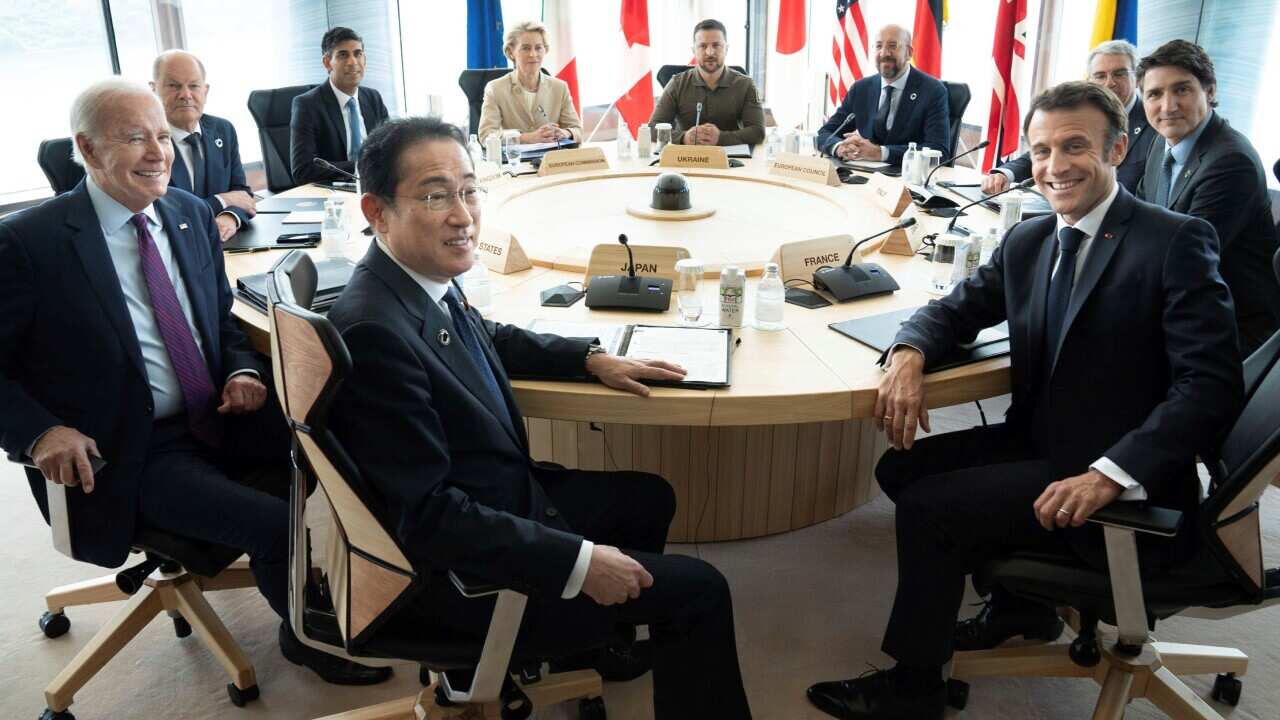 Ukrainian President Volodymyr Zelenskyy, center rear, joins G7 world leaders at a working session on the final day of the G7 Summit in Hiroshima, Japan, Sunday, May 21, 2023
