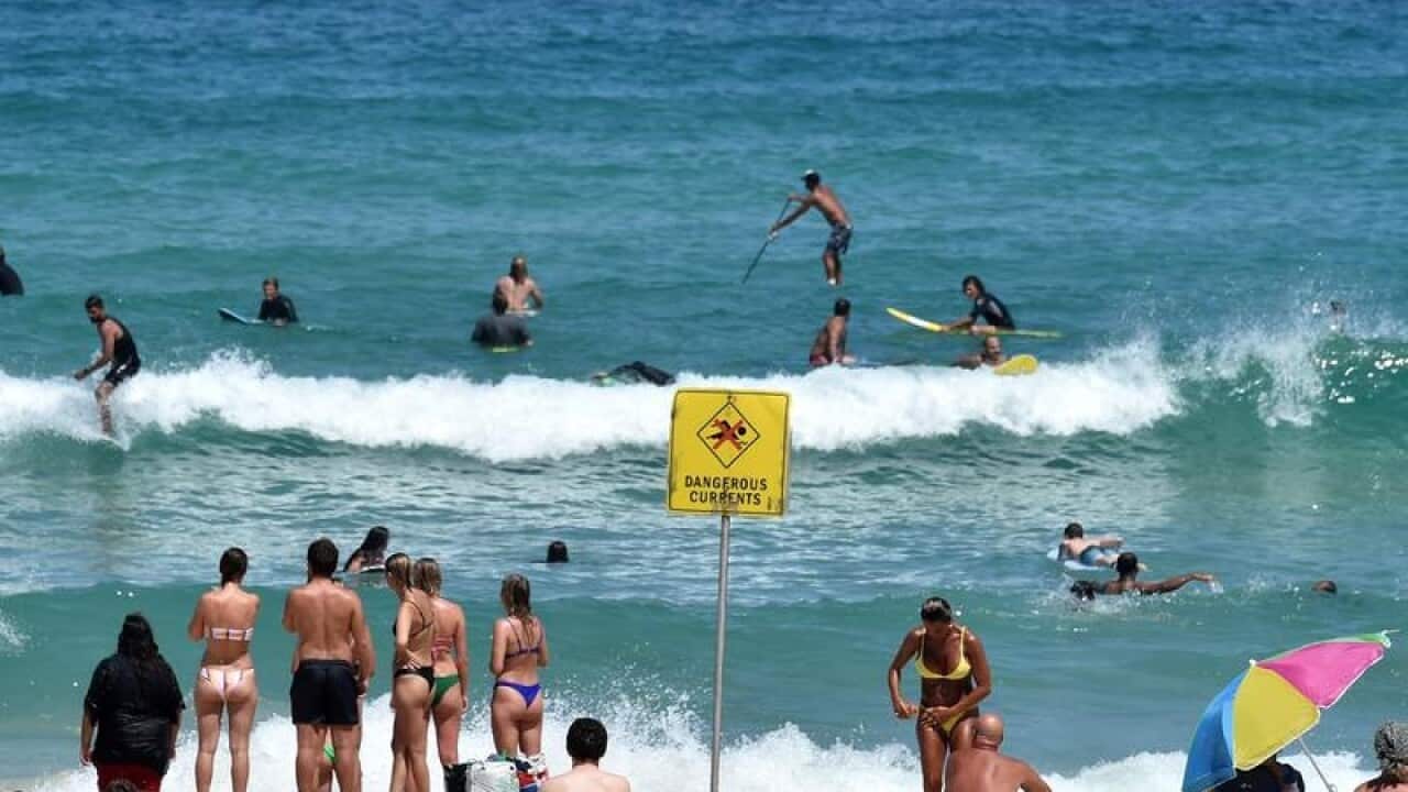 Beachgoers and surfers are seen at Bondi Beach (file image)