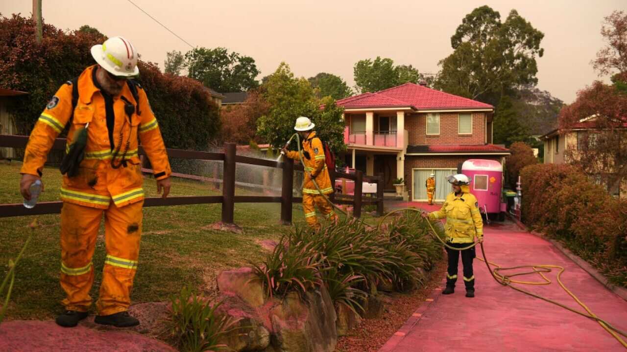 Chemical fire retardant is seen after being dropped to protect houses on Canoon Rd and Barwon Avenue South Turramurra, north of Sydney, Tuesday, 12 November