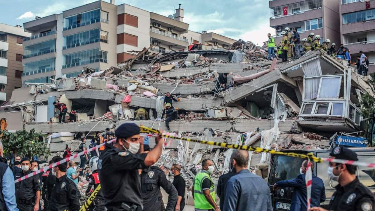 Rescuers search for survivors at a collapsed building after a powerful earthquake struck Turkey's western coast and parts of Greece.