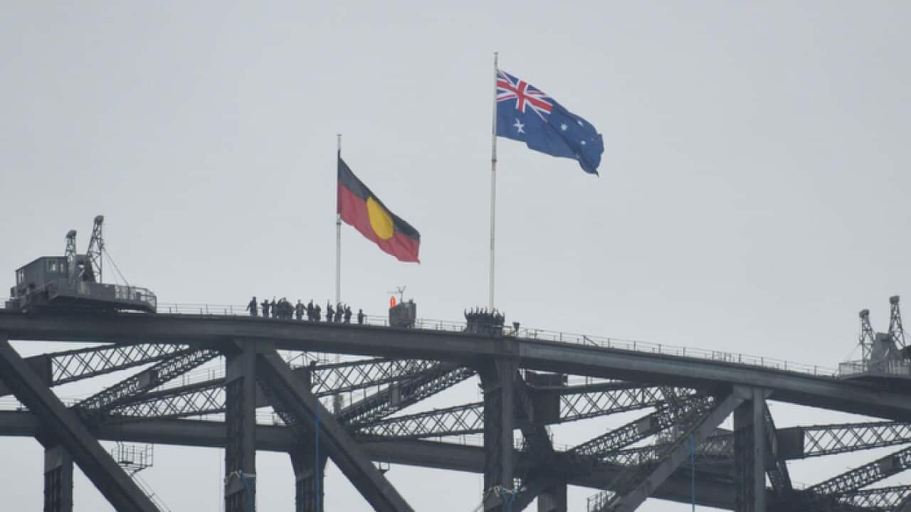 Australian and Aboriginal flags seen on the Harbour Bridge as part of Australia Day celebrations in Sydney