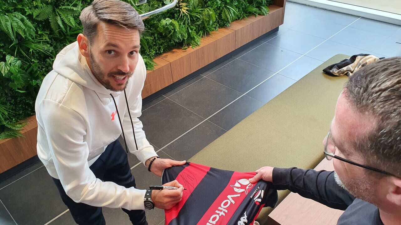 Milos Ninkovic signs shirt to a Western Sydney Wanderers fan