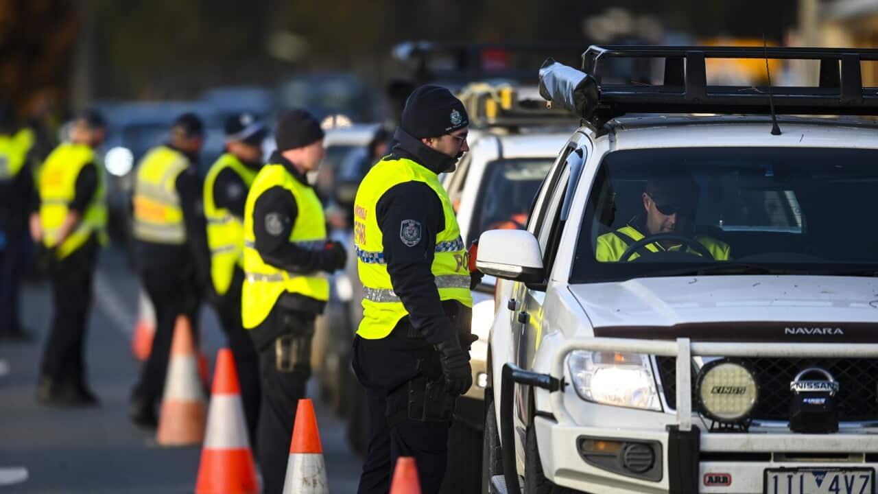 NSW Police officers check cars crossing from Victoria into New South Wales at a border check point in Albury, NSW, Wednesday, 8 July, 2020.
