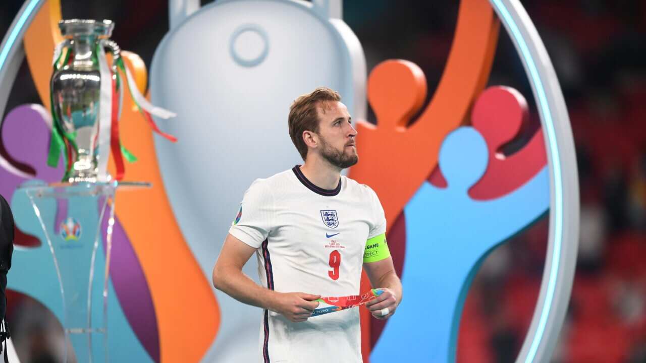 Harry Kane walks past the Euro 2020 trophy after England's defeat