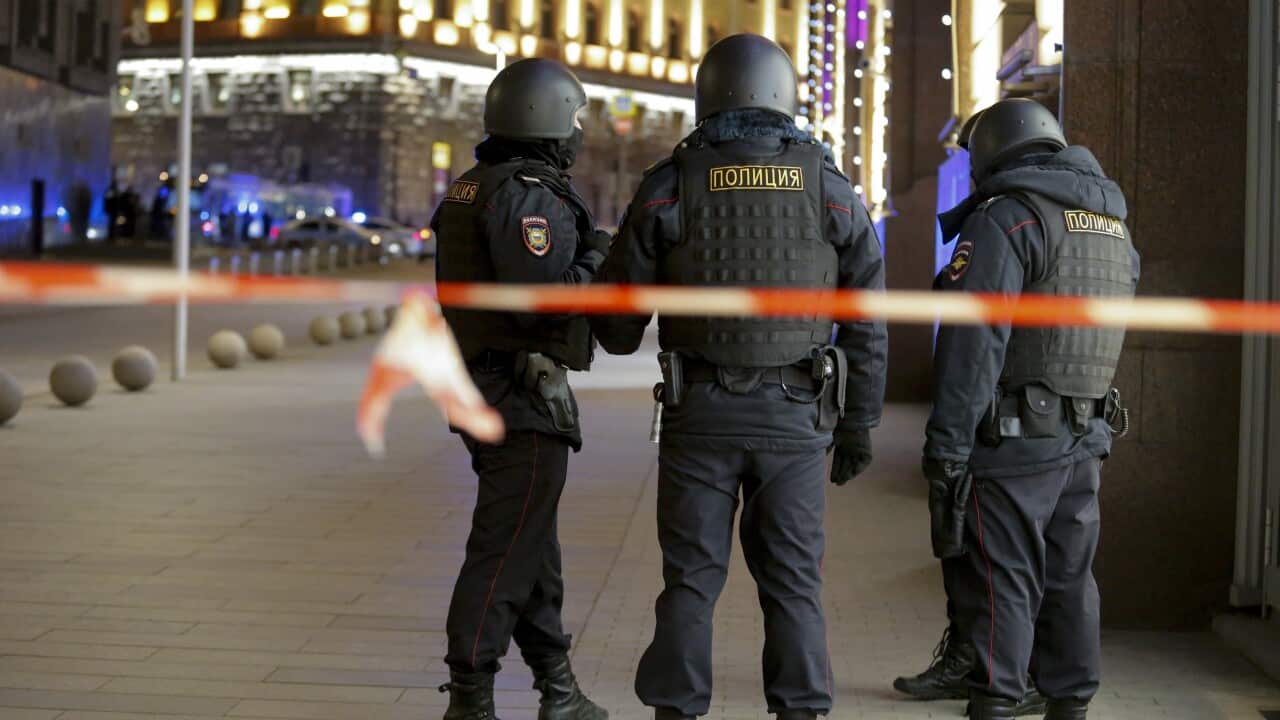 Russian police officers secure the area near the building of the Federal Security Service.