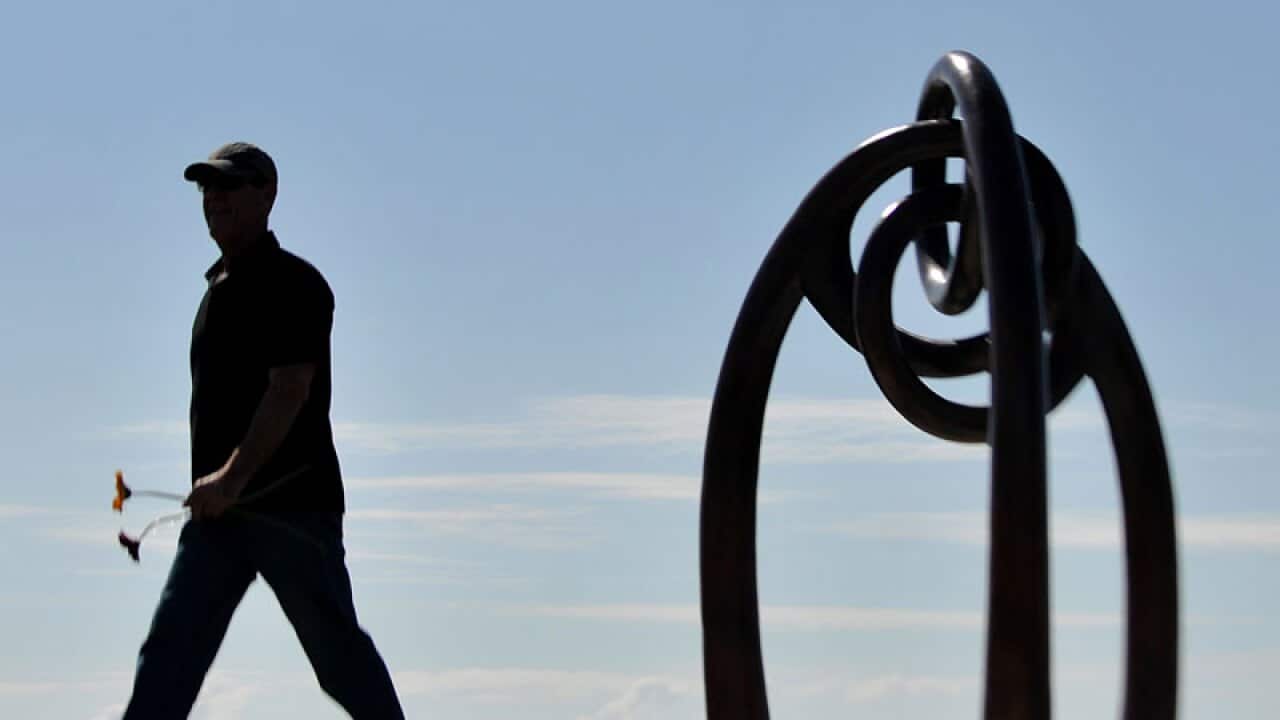 A mourner remembers the ninth anniversary of the Bali bombings at a memorial service at Coogee Beach, Sydney, in this file photo from 2013.