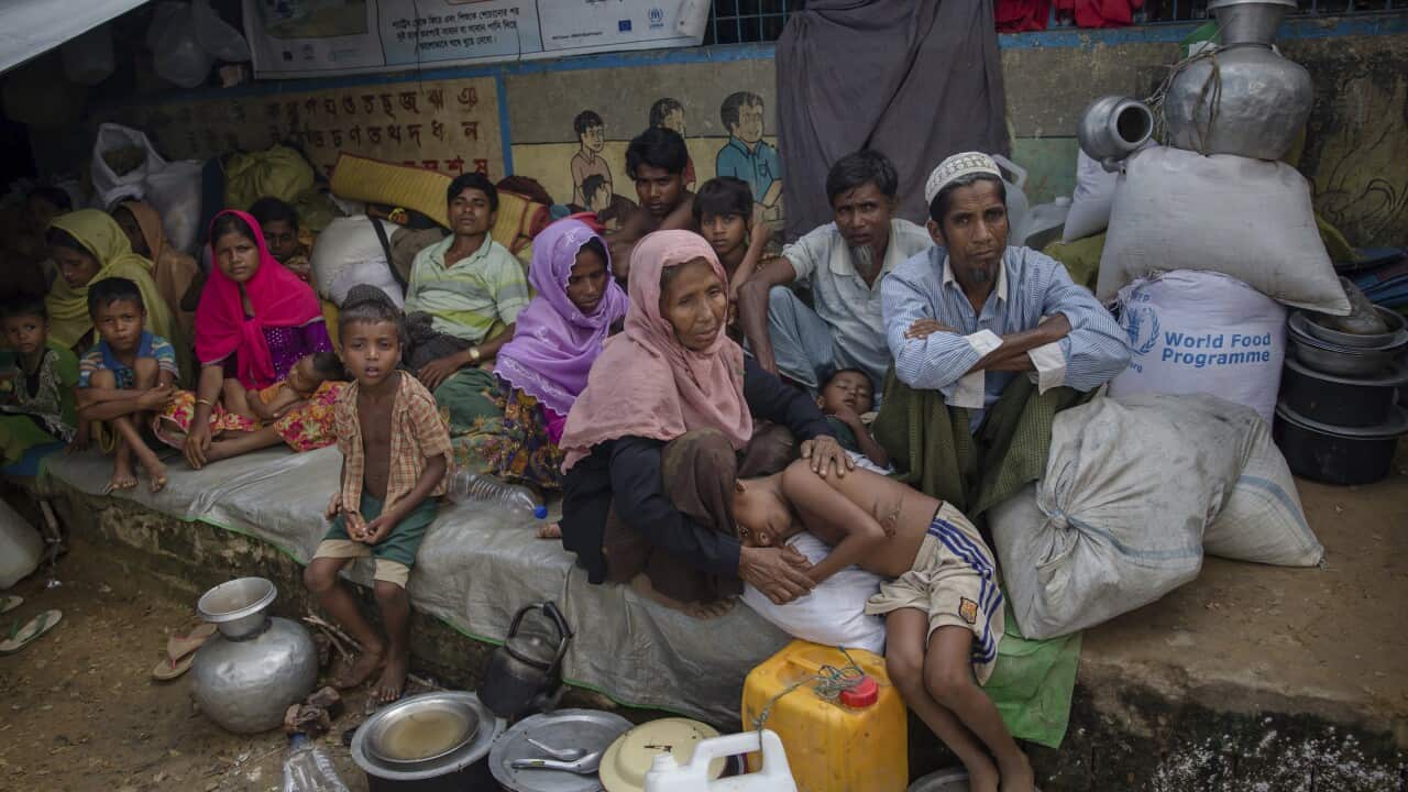 Rohingya Muslims who crossed from Myanmar into Bangladesh rest inside a school compound at Kutupalong refugee camp.