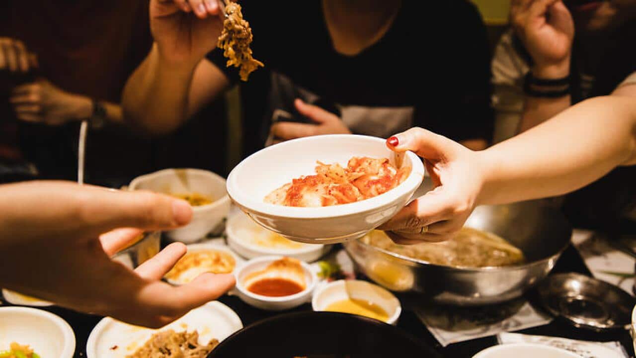 Friends sharing Korean food together