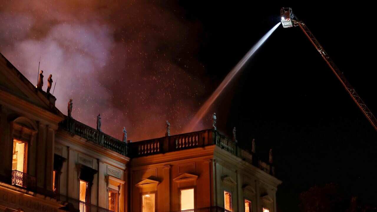 Firefighters battle the blaze.