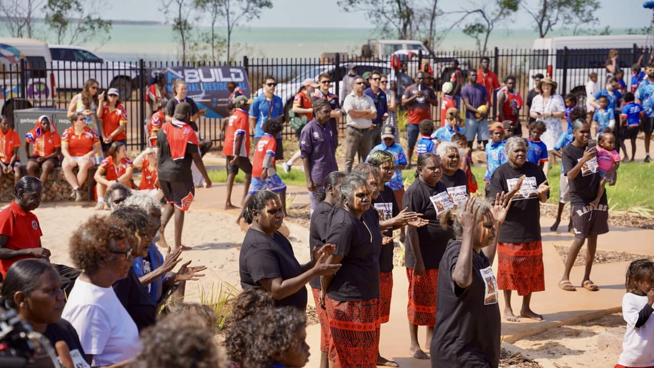 A group of Wurrumiyanga residents singing and dancing together