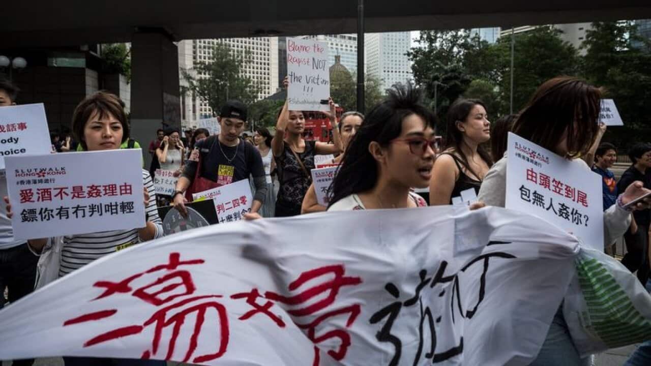 eople walk along a street during the fifth annual 'SlutWalk' in Hong Kong on October 30, 2016, to protest against sexual violence, victim blaming and rape culture.The campaign, which has gained international notoriety, was inspired by a group of Canadian