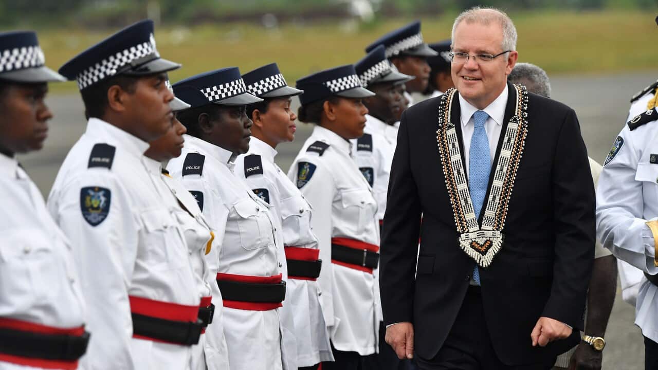 Australian Prime Minister Scott Morrison (right) inspecting an honour guard of the Royal Solomon Islands Police Force.